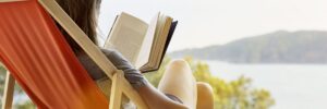 woman-reading-book-while-relaxing-on-deck-high-res-stock-photography-604176571-1540232706