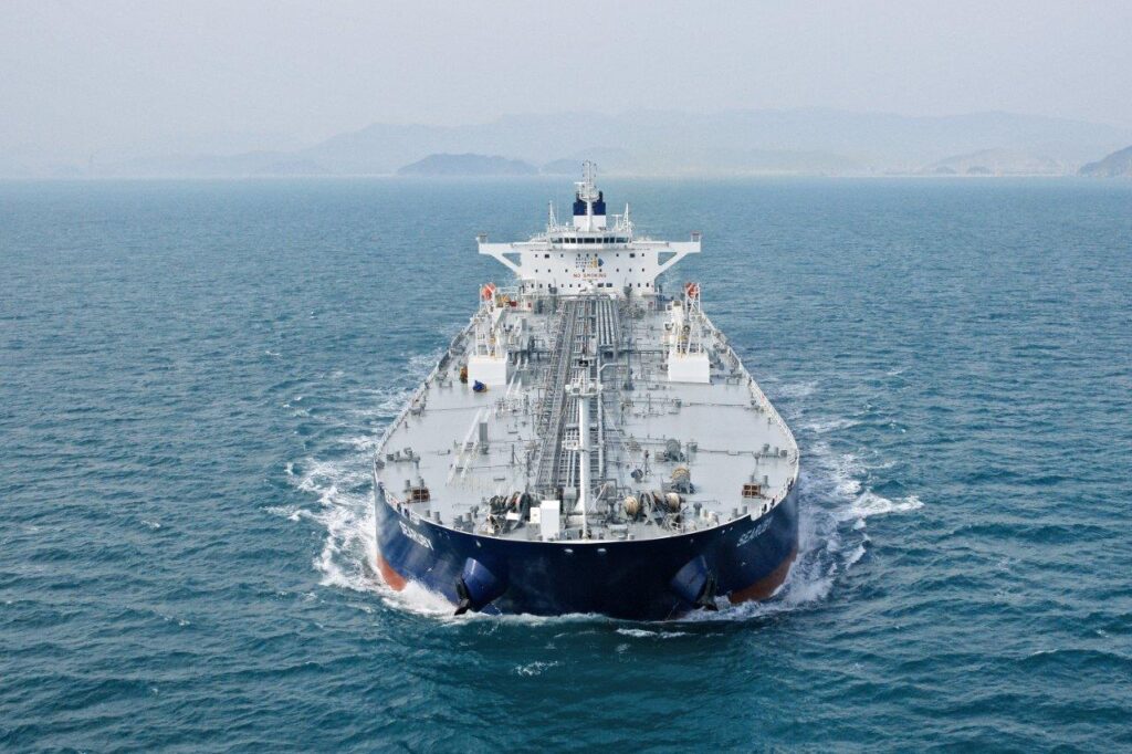 A photograph of the SEARUBY, a ship owned by shipping company Thenamaris, from a front perspective. The SEARUBY is in motion with a foggy coastline in its background. The photo accompanies a blog post about what Thenamaris learned after using personality tests for talent development. Thenamaris's use of Hogan personality assessments for talent development led to a number of positive business outcomes outlined in the blog.