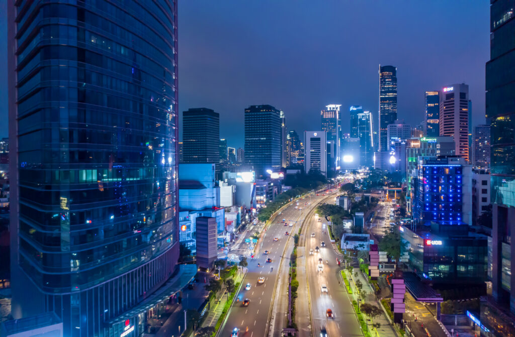 An aerial photo of downtown Jakarta, Indonesia, at night accompanies a blog post about personality characteristics of the Indonesian workforce and personality-industry alignment