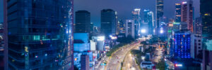 An aerial photo of downtown Jakarta, Indonesia, at night accompanies a blog post about personality characteristics of the Indonesian workforce and personality-industry alignment