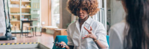 two multiracial students discussing project in co working office
