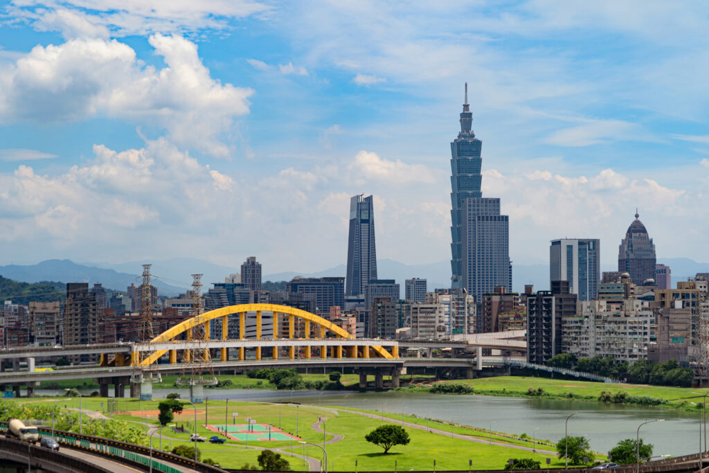 Aerial view of Taipei Downtown, Taiwan. Financial district and business centers in smart urban city. Skyscraper and high-rise buildings at noon.