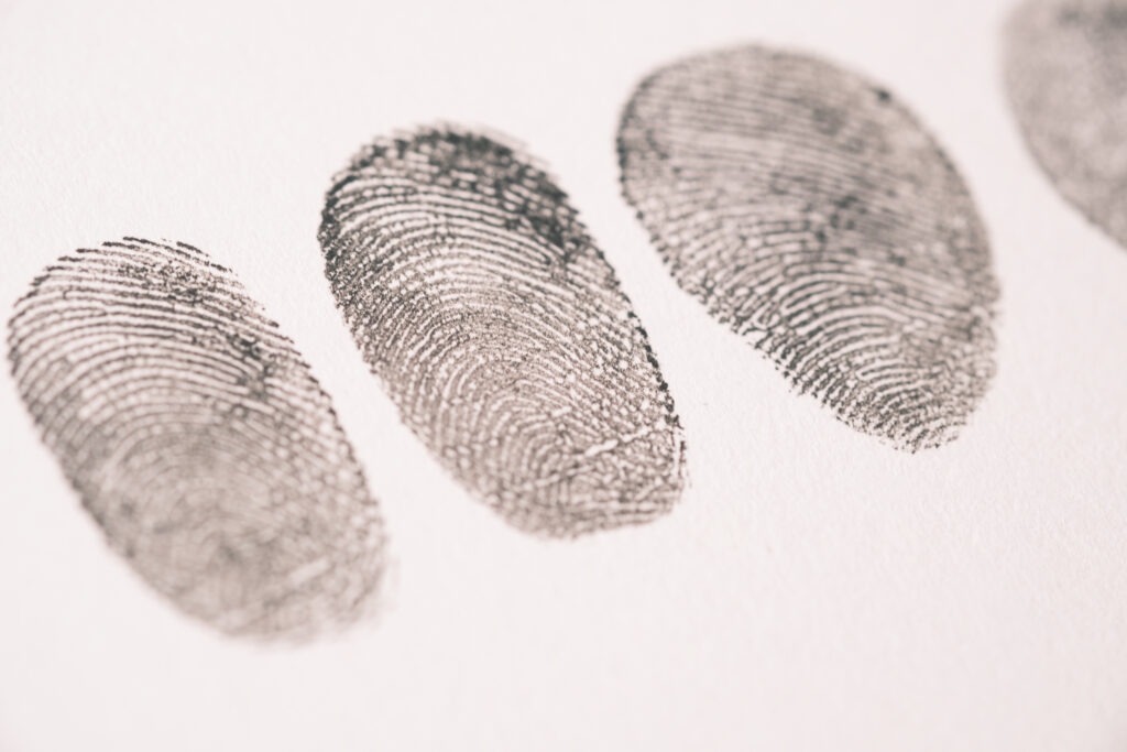 putting fingerprints on a paper close up ,