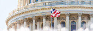 US Congress dome closeup with background of water fountain splashing, American flag waving in Washington DC, USA closeup on Capital capitol hill, columns, pillars, nobody