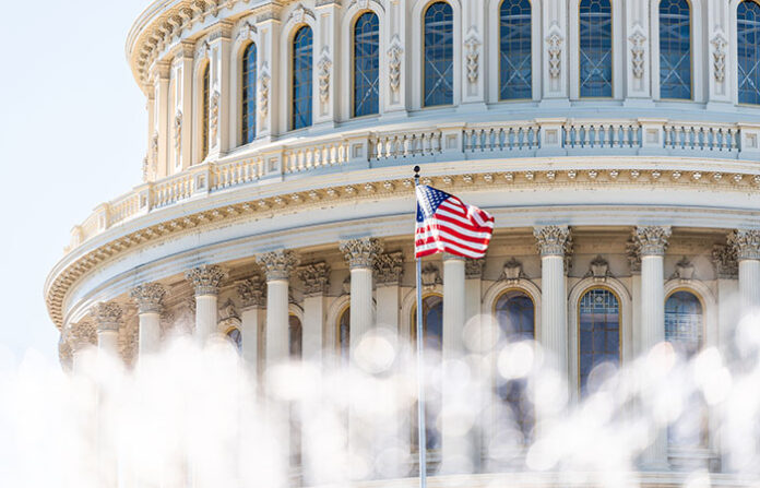 US Congress dome closeup with background of water fountain splashing, American flag waving in Washington DC, USA closeup on Capital capitol hill, columns, pillars, nobody